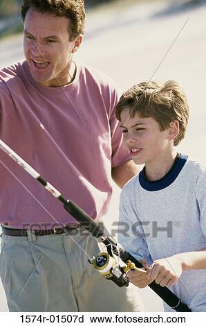 Father and son fishing on the beach View Large Photo Image Stock Image - Father and son fishing on the beach. Fotosearch