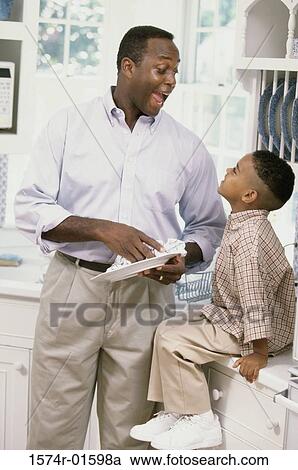 Stock Image - Father and son looking at each other. Fotosearch
