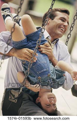 Stock Image - Father and son on a playground. Fotosearch