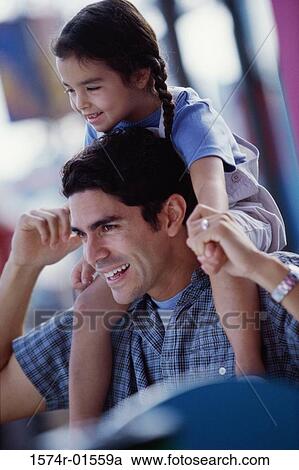 Father carrying his daughter on his shoulders View Large Photo Image Stock Image - Father carrying his daughter on his shoulders. Fotosearch