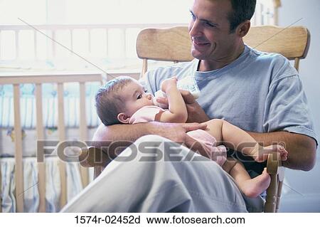 Father feeding his baby boy View Large Photo Image Stock Image - Father feeding his baby boy. Fotosearch