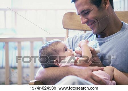 Father feeding his baby boy View Large Photo Image Stock Image - Father feeding his baby boy. Fotosearch