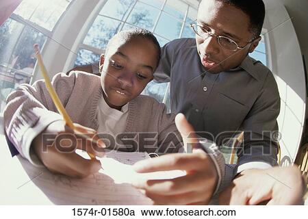 Father helping his daughter with her homework View Large Photo Image Stock Image - Father helping his daughter with her homework. Fotosearch