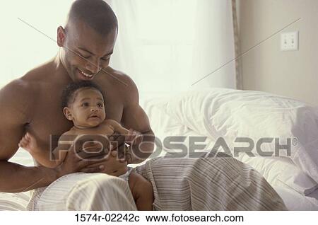 Father holding his baby boy View Large Photo Image Stock Image - Father holding his baby boy. Fotosearch