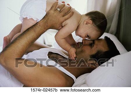Father holding his baby boy View Large Photo Image Stock Image - Father holding his baby boy. Fotosearch