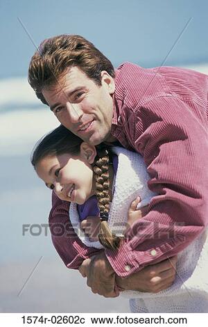 Father hugging his daughter on the beach View Large Photo Image Stock Image - Father hugging his daughter on the beach. Fotosearch