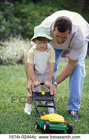 Father teaching his daughter to mow a lawn View Large Photo Image Stock Image - Father teaching his daughter to mow a lawn. Fotosearch