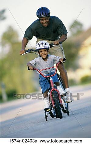 Stock Image - Father teaching his son fishing. Fotosearch