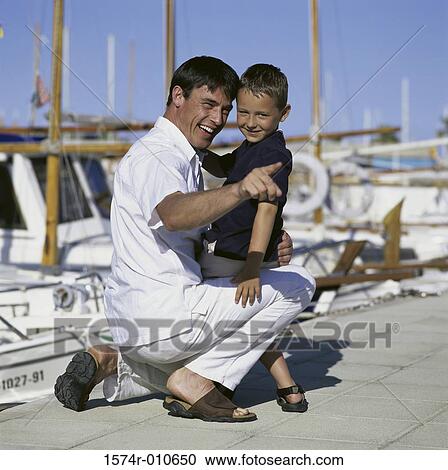 Father with his son on a dock View Large Photo Image Stock Image - Father with his son on a dock. Fotosearch