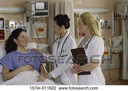 Female doctor and a female nurse with a female patient View Large Photo Image Stock Image - Female doctor and a female nurse with a female patient. Fotosearch