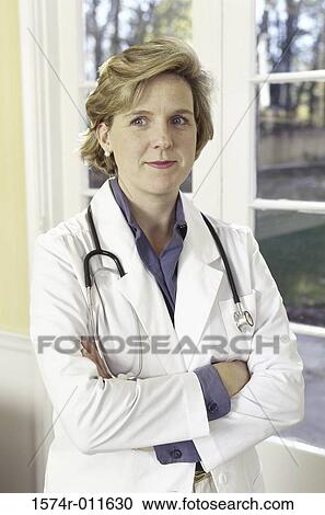 Female doctor standing with a stethoscope around her neck View Large Photo Image Stock Image - Female doctor standing with a stethoscope around her neck. Fotosearch