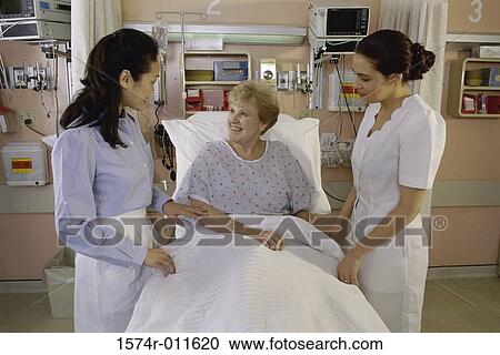 Stock Image - Female nurses with a female patient. Fotosearch