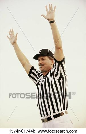 Football referee whistling with his arms raised View Large Photo Image Stock Image - Football referee whistling with his arms raised. Fotosearch