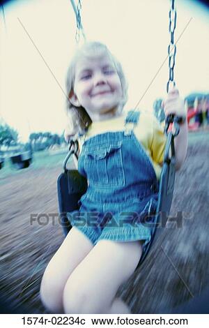 Girl sitting on a swing View Large Photo Image Stock Image - Girl sitting on a swing. Fotosearch