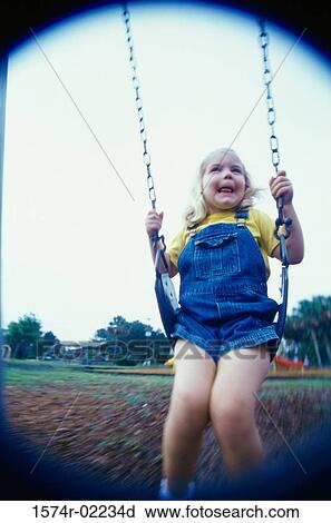 Stock Image - Girl sitting on a swing. Fotosearch
