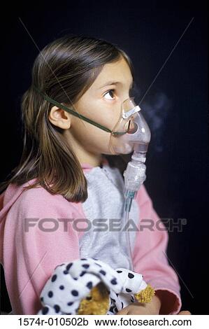 Stock Image - Girl wearing an oxygen mask. Fotosearch