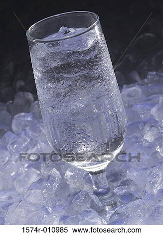 Stock Photography - Glass of ice water on ice. Fotosearch