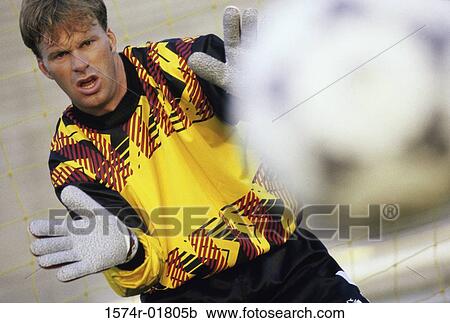 Stock Image - Goalie attempting to stop a soccer ball. Fotosearch