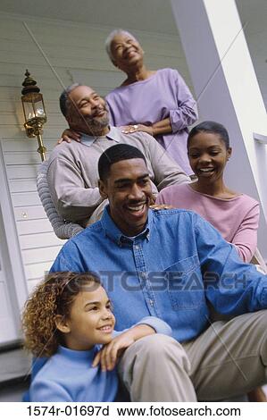 Grandparents sitting on the front porch with their son and granddaughter View Large Photo Image Stock Image - Grandparents sitting on the front porch with their son and granddaughter. Fotosearch