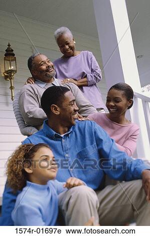 Grandparents sitting on the front porch with their son and granddaughter View Large Photo Image Stock Image - Grandparents sitting on the front porch with their son and granddaughter. Fotosearch