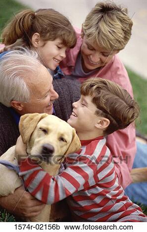 Grandparents with their grandson and granddaughter holding their dog View Large Photo Image Stock Image - Grandparents with their grandson and granddaughter holding their dog. Fotosearch