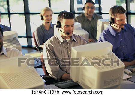Stock Image - Group of business executives working on computers. Fotosearch
