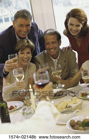 Stock Image - Group of people celebrating with glasses of wine. Fotosearch