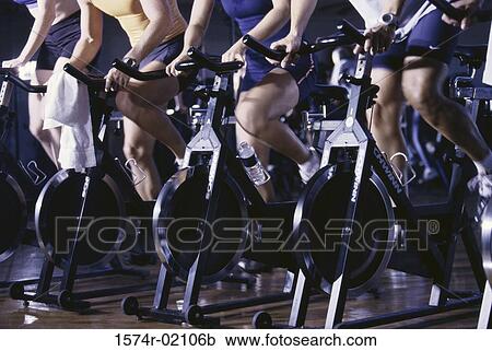 Stock Image - Group of people exercising in a health club. Fotosearch