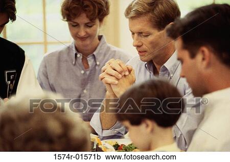 Stock Image - Group of people praying. Fotosearch