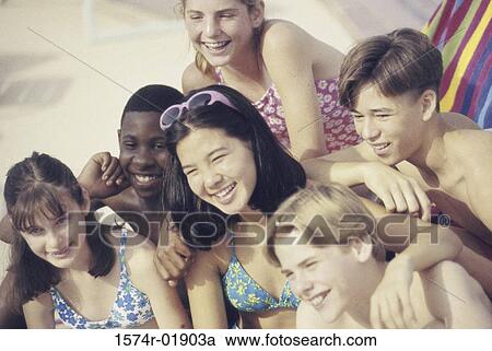 Stock Image - Group of teenagers at the beach. Fotosearch