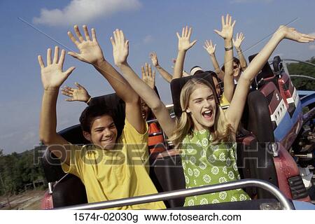 Group of teenagers riding a rollercoaster View Large Photo Image Stock Image - Group of teenagers riding a rollercoaster. Fotosearch