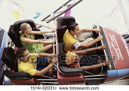 Group of teenagers riding a rollercoaster View Large Photo Image Stock Image - Group of teenagers riding a rollercoaster. Fotosearch