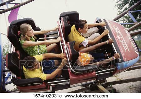 Stock Image - Group of teenagers riding a rollercoaster. Fotosearch