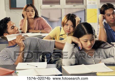 Group of teenagers sitting in a classroom View Large Photo Image Stock Image - Group of teenagers sitting in a classroom. Fotosearch