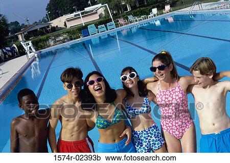 Group of teenagers standing beside a swimming pool View Large Photo Image Stock Image - Group of teenagers standing beside a swimming pool. Fotosearch