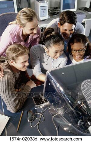 Group of young people in front of a computer monitor View Large Photo Image Stock Image - Group of young people in front of a computer monitor. Fotosearch