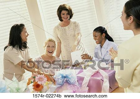 Stock Image - Group of young women at a baby shower. Fotosearch