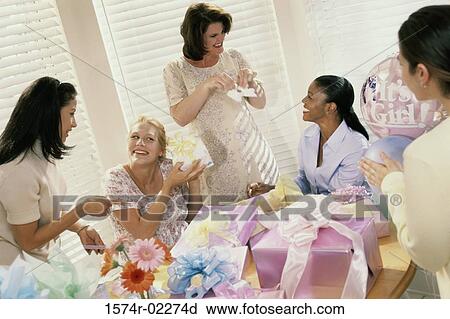 Stock Image - Group of young women at a baby shower. Fotosearch