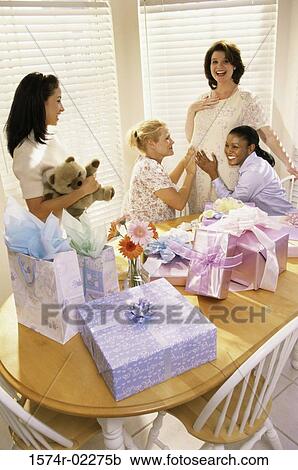 Stock Image - Group of young women at a baby shower. Fotosearch