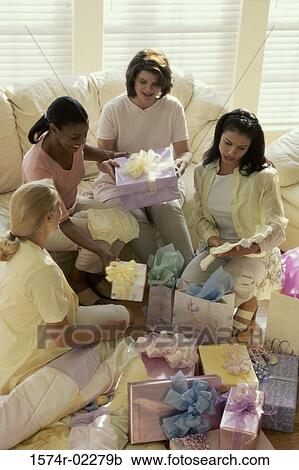 Stock Image - Group of young women sitting together at a baby shower. Fotosearch