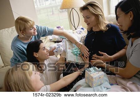 Stock Image - Group of young women sitting together at a baby shower. Fotosearch