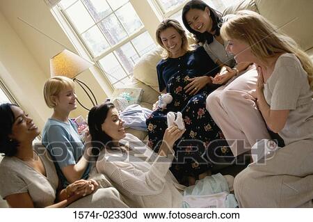 Stock Image - Group of young women sitting together at a baby shower. Fotosearch