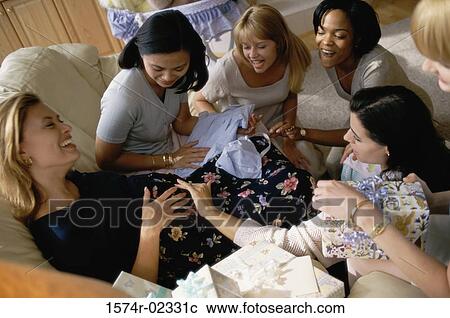 Stock Image - Group of young women sitting together at a baby shower. Fotosearch