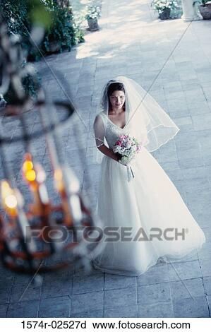High angle view of a bride holding a bouquet of flowers View Large Photo Image Stock Image - High angle view of a bride holding a bouquet of flowers. Fotosearch