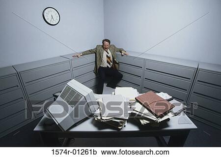 Stock Image - High angle view of a businessman standing in the corner of a room screaming. Fotosearch