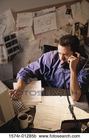 High angle view of a businessman talking on a telephone View Large Photo Image Stock Image - High angle view of a businessman talking on a telephone. Fotosearch