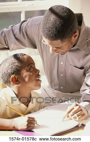 High angle view of a father teaching his son View Large Photo Image Stock Image - High angle view of a father teaching his son. Fotosearch