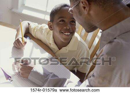 High angle view of a father teaching his son View Large Photo Image Stock Image - High angle view of a father teaching his son. Fotosearch