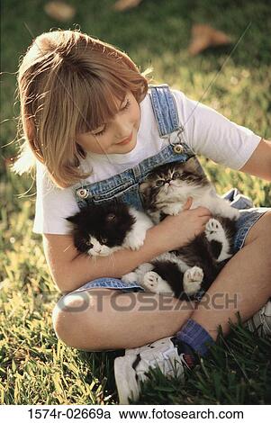 High angle view of a girl holding cats View Large Photo Image Stock Image - High angle view of a girl holding cats. Fotosearch