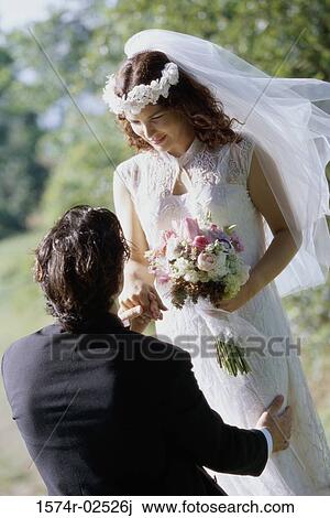 High angle view of a groom giving a bouquet of flowers to his bride View Large Photo Image Stock Image - High angle view of a groom giving a bouquet of flowers to his bride. Fotosearch